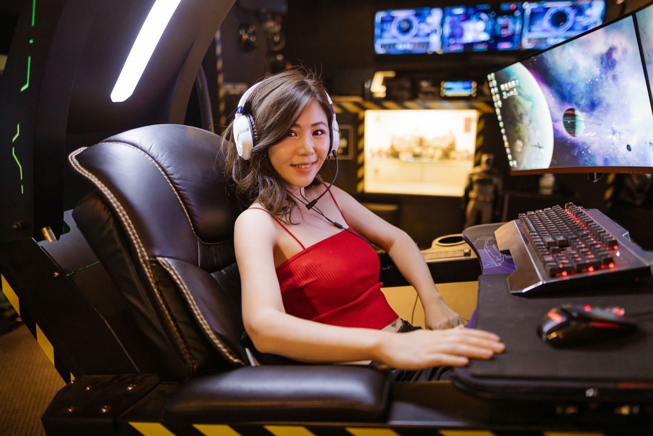 Woman smiling while playing a computer game